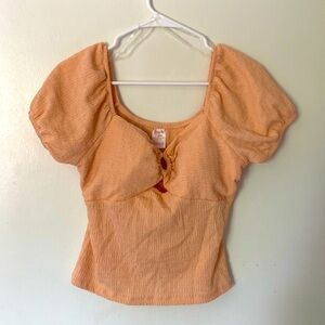 Peach on or off the shoulder polyester, detailed shirt with a